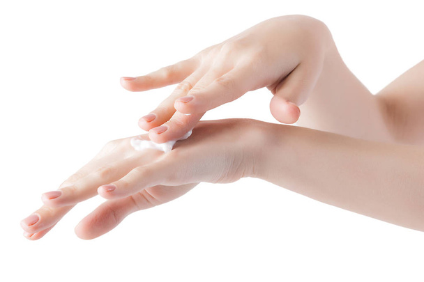Mujer joven aplicando crema de manos. Manos con crema hidratante
. - Foto, imagen