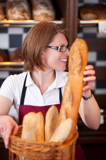Woman working in a bakery - 写真・画像