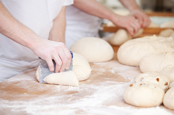 Bakers making handmade loaves of bread - Fotoğraf, Görsel
