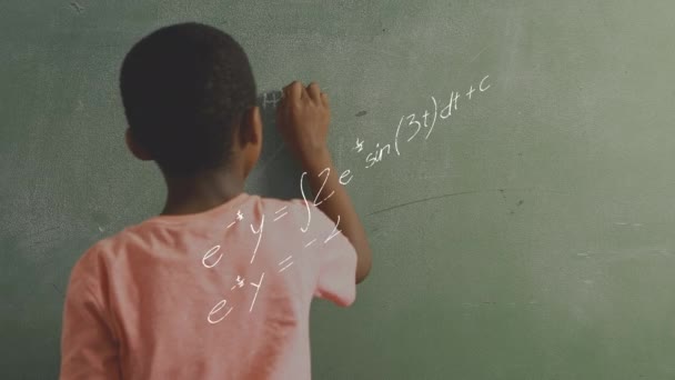 Digital composite of an African-American boy writing on the chalkboard while mathematical equations move in the foreground - Video