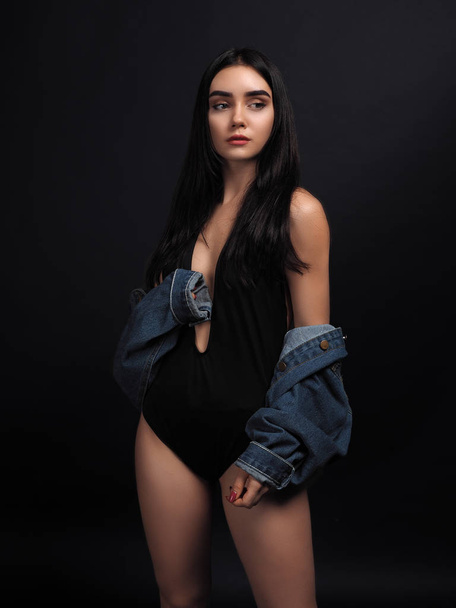 Model brunette posing isolated at black - Foto, imagen