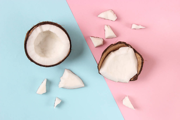 broken coconut on a colored background top view. - 写真・画像
