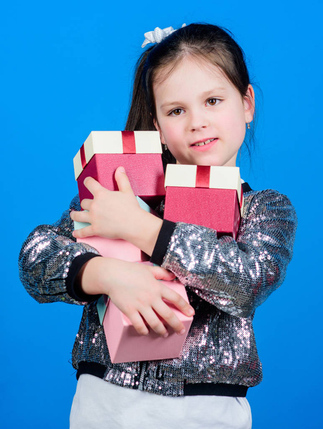 Black friday. Shopping day. Child carry lot gift boxes. Kids fashion. Surprise gift box. Birthday wish list. Special happens every day. Shop for what you want. Girl with gift boxes blue background - Fotoğraf, Görsel