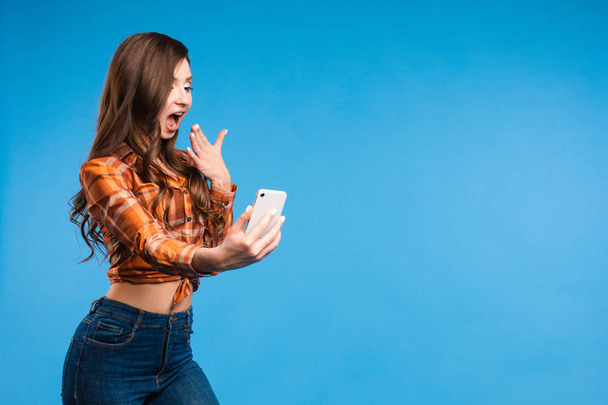 junges verführerisches Mädchen macht Fotos, auf denen sie steht und ein Selfie mit dem Smartphone macht - Foto, Bild