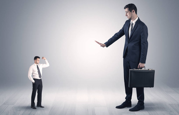 Giant businessman scared of small businessman - Photo, Image