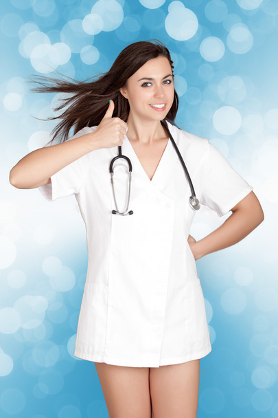 attractive female doctor woman show thumbs up hand sign - Fotó, kép