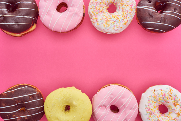 top view of tasty glazed doughnuts on pink background with copy space - Zdjęcie, obraz