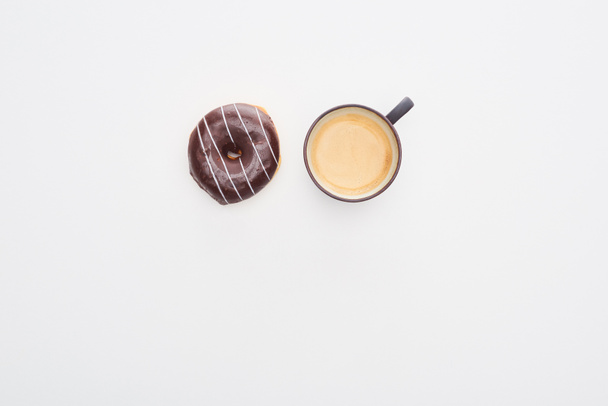 top view of tasty glazed chocolate doughnut and coffee cup on white background - Zdjęcie, obraz