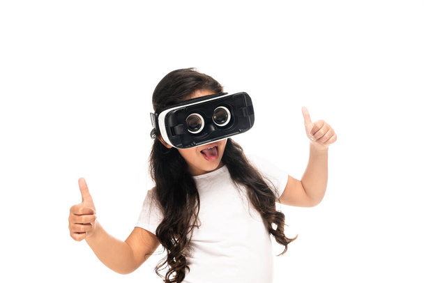 Latin gyermek mutató remek, miközben visel virtuális valóság headset elszigetelt fehér  - Fotó, kép