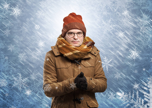 Boy freezing in warm clothing and snowing concept - Foto, Imagem