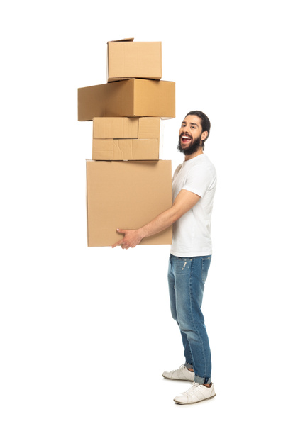 cheerful latin man holding carton boxes and smiling isolated on white  - Photo, Image
