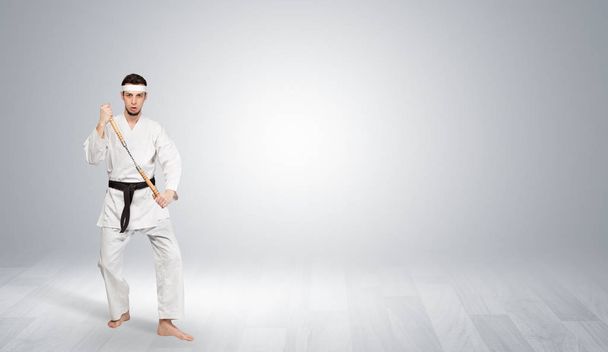 Karate trainer fighting in an empty space - Photo, image