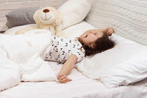 cute little child girl wakes up from sleep - Valokuva, kuva