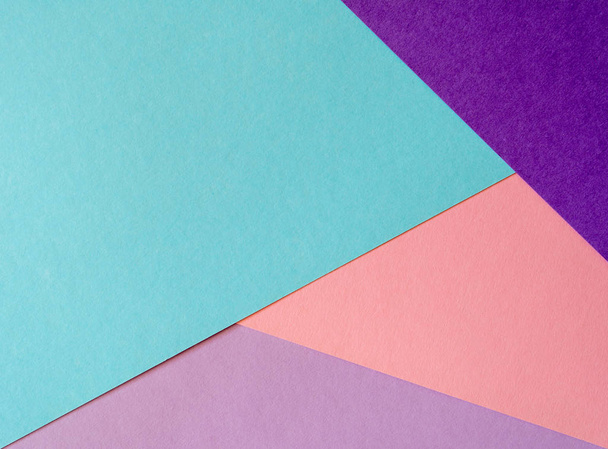 Multicolored paper background in soft blue, violet, lilac and coral colors. - Фото, изображение