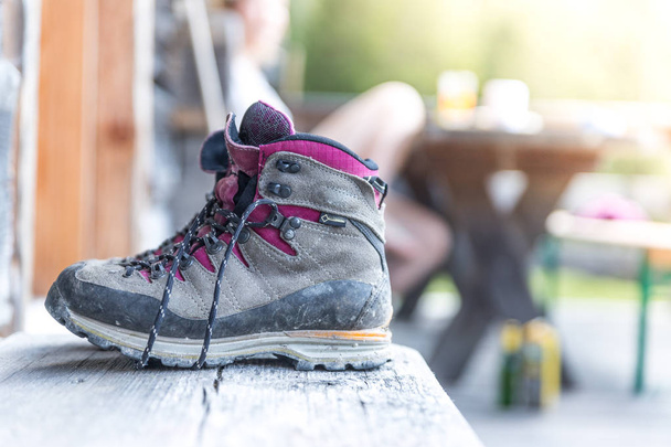 Trekking boots on the veranda of an alpine hut. Summer holidays  - Foto, Imagen