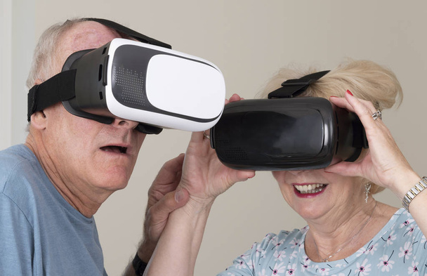 Portsmouth UK, May 2019. Elderly couple having fun wearing virtual reality goggles - Foto, afbeelding