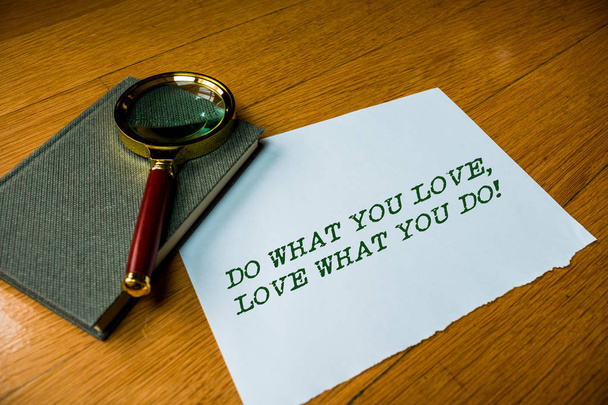 Text sign showing Do What You Love Love What You Do. Conceptual photo you able doing stuff you enjoy it to work in better places then Close up electronic device gadget magnifying glass resting wooden - Photo, Image