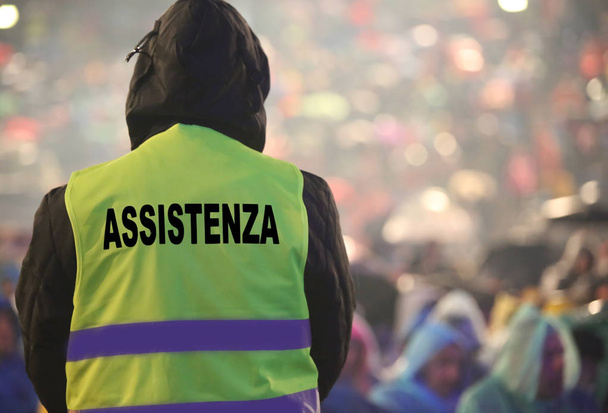 boy with high visibility jacket and the text that means ASSISTAN - Photo, Image