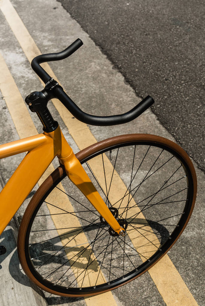 Vintage yellow color bike park on road side
 - Фото, изображение