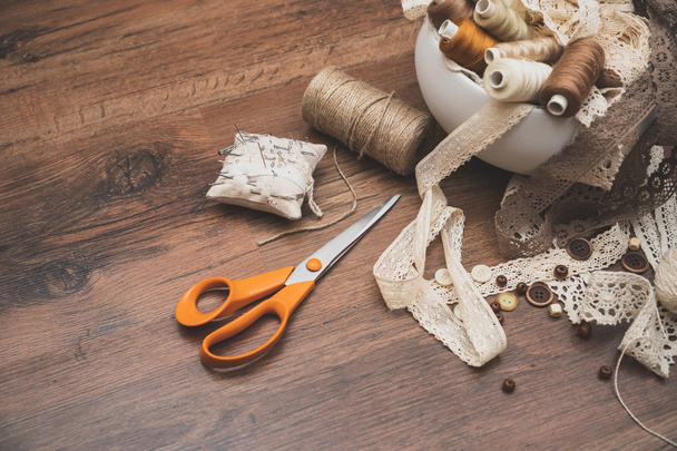 Sewing concept. Scissors, thread spools, buttons and sewing needles. - Photo, Image