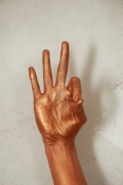 Hands in gold paint, the hands of the artist and creative person.Yoga for hands - Foto, Imagem