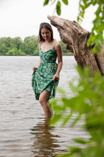 White woman stands near a beautiful lake - Zdjęcie, obraz