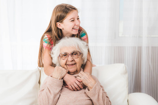 Granddaughter hugging grandmother - Фото, изображение