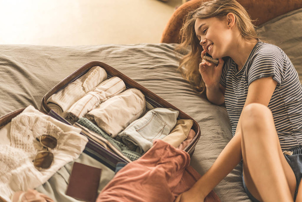 Summer travel and vacation concept,Young woman packing suitcase  - Photo, image