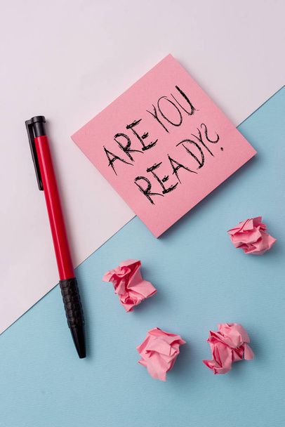Writing note showing Are You Ready Question. Business photo showcasing used telling someone start something when feel prepared Note papers and stationary placed sideways on top of softhued backdrop. - Photo, Image