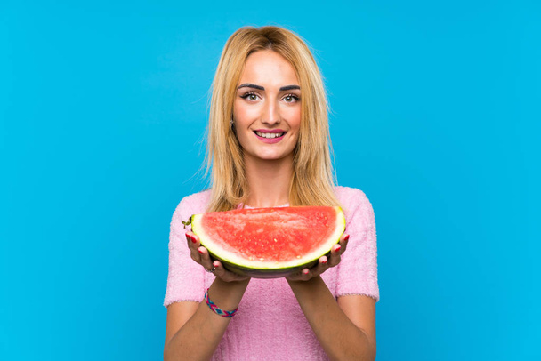 Young blonde woman holding fruits - Photo, Image