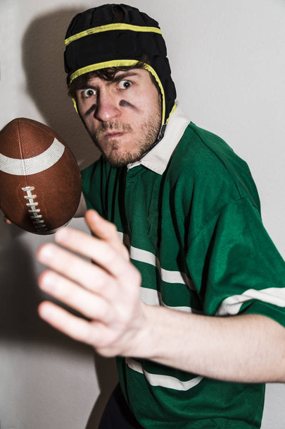 Rugby player holding ball and prepared for throw - Foto, Imagen
