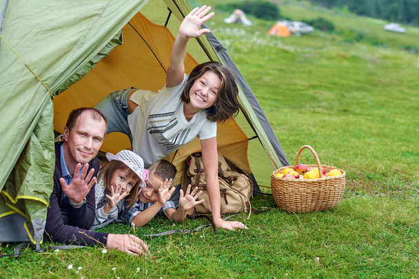 Family Parents and two children in camp tent. Happy Mother, father, son and daughter on Summer vacation - Zdjęcie, obraz