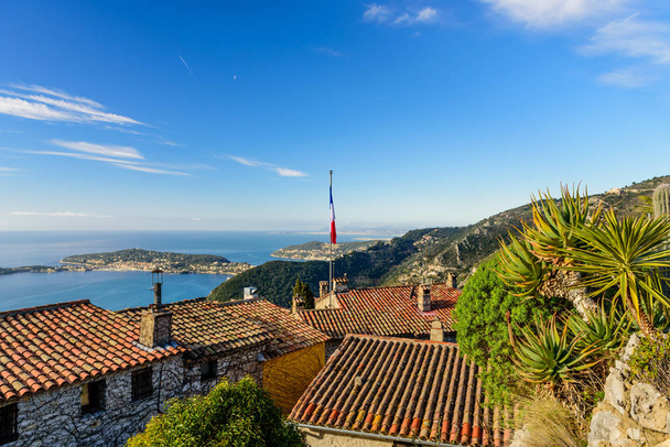 Scenic view of the Mediterranean coastline and medieval houses from the top of the town of Eze village on the French Riviera, France - Zdjęcie, obraz