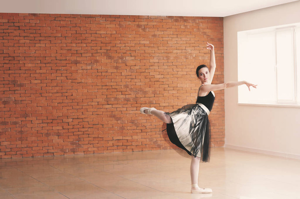 Beautiful young ballerina in dance studio - Photo, Image