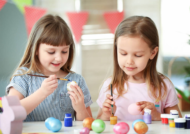 Little children painting Easter eggs at home - Фото, зображення