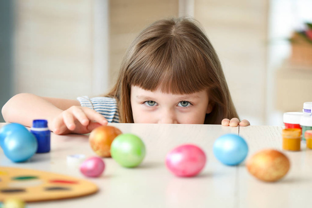 Cute little girl with painted Easter eggs at home - Photo, Image