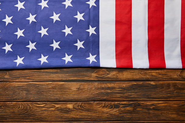 top view of usa flag on wooden brown background with copy space - Foto, Imagen
