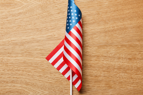top view of american flag on stick on wooden surface  - Fotó, kép