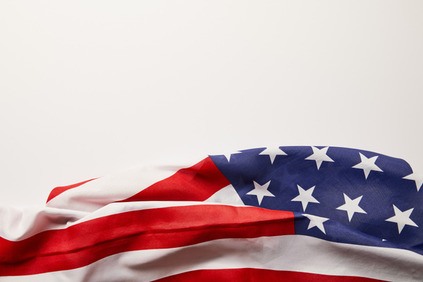 top view of crumpled american flag on white surface with copy space - Foto, Imagem