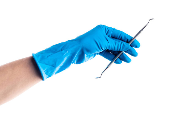 Hand in blue glove holding dental metal stick isolated - Foto, afbeelding