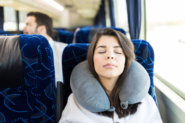 Mid adult passenger with neck pillow napping in travel bus - Photo, Image