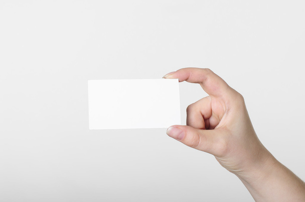Hand with white card on a white background - Φωτογραφία, εικόνα
