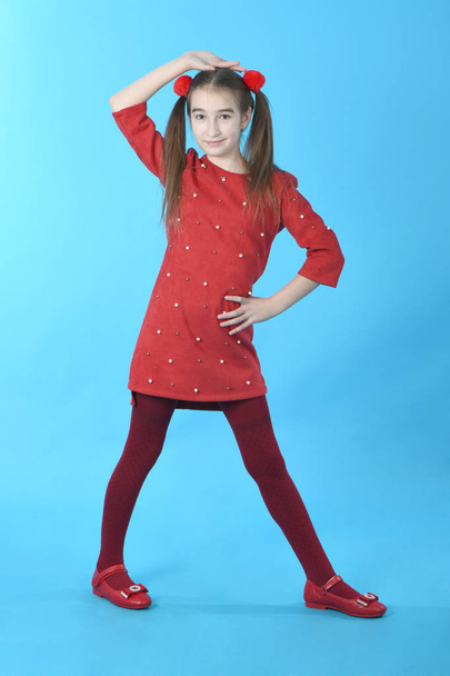 Full length studio photo girl wearing red dress standing - Фото, изображение