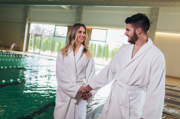 Happy young couple enjoying treatments and relaxing at wellness  - Fotografie, Obrázek