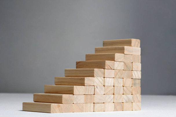 stairs build with wooden blocks on grey background - Foto, Bild