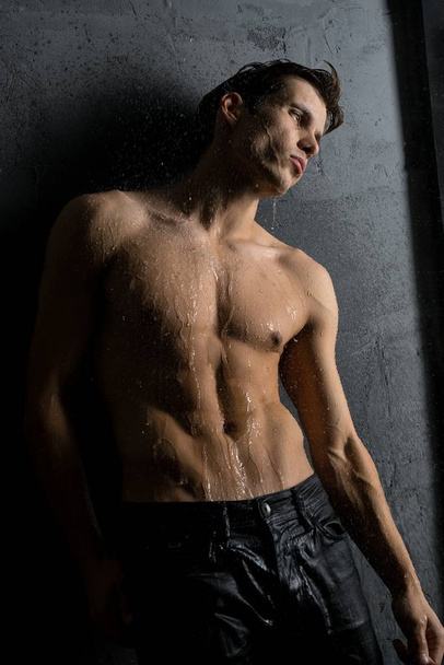 Shirtless muscular man in shower view - Фото, зображення