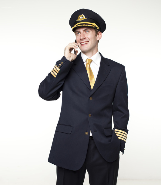 Young man in the form of a passenger plane pilot - Foto, afbeelding