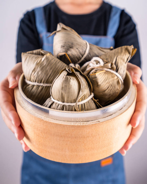 Zongzi, delicious steamed rice dumplings in steamer in black background for dragon boat duanwu festival, close up, copy space, top view, flat lay - Fotoğraf, Görsel