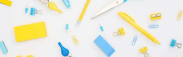 panoramic shot of mixed yellow and blue stationery isolated on white - Fotografie, Obrázek