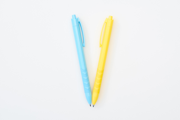 top view of yellow and blue crossed pencils isolated on white - Foto, immagini